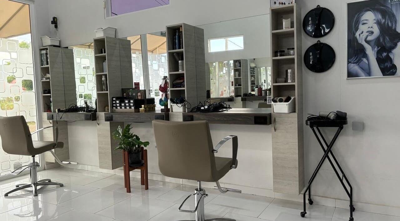 Modern salon interior at Mel An Gi Hair NV, Paramaribo, Paramaribo, SR with stylish chairs and sleek mirrors.