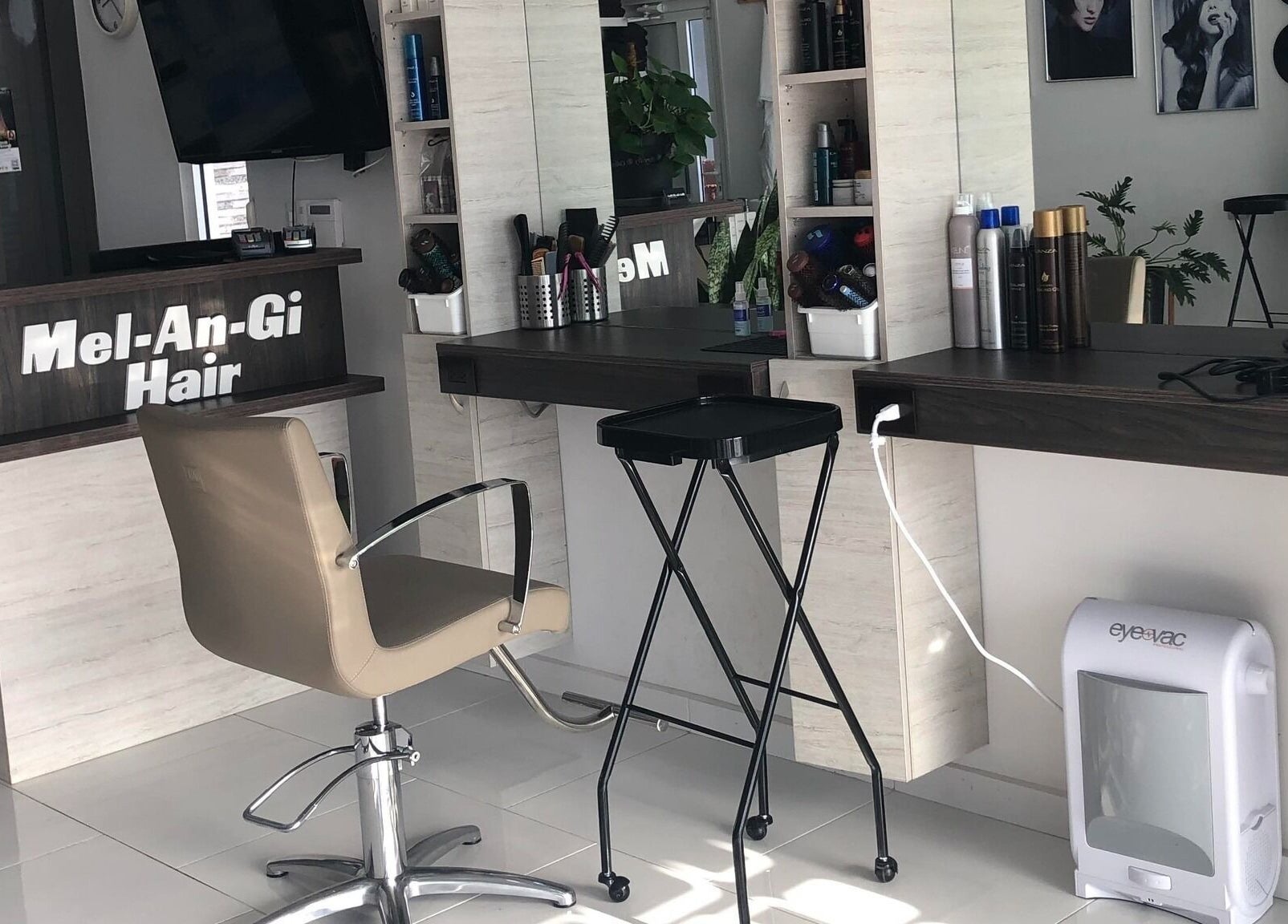 Chic salon workstation at Mel An Gi Hair NV in Paramaribo, Paramaribo, SR, featuring modern decor and beauty products.