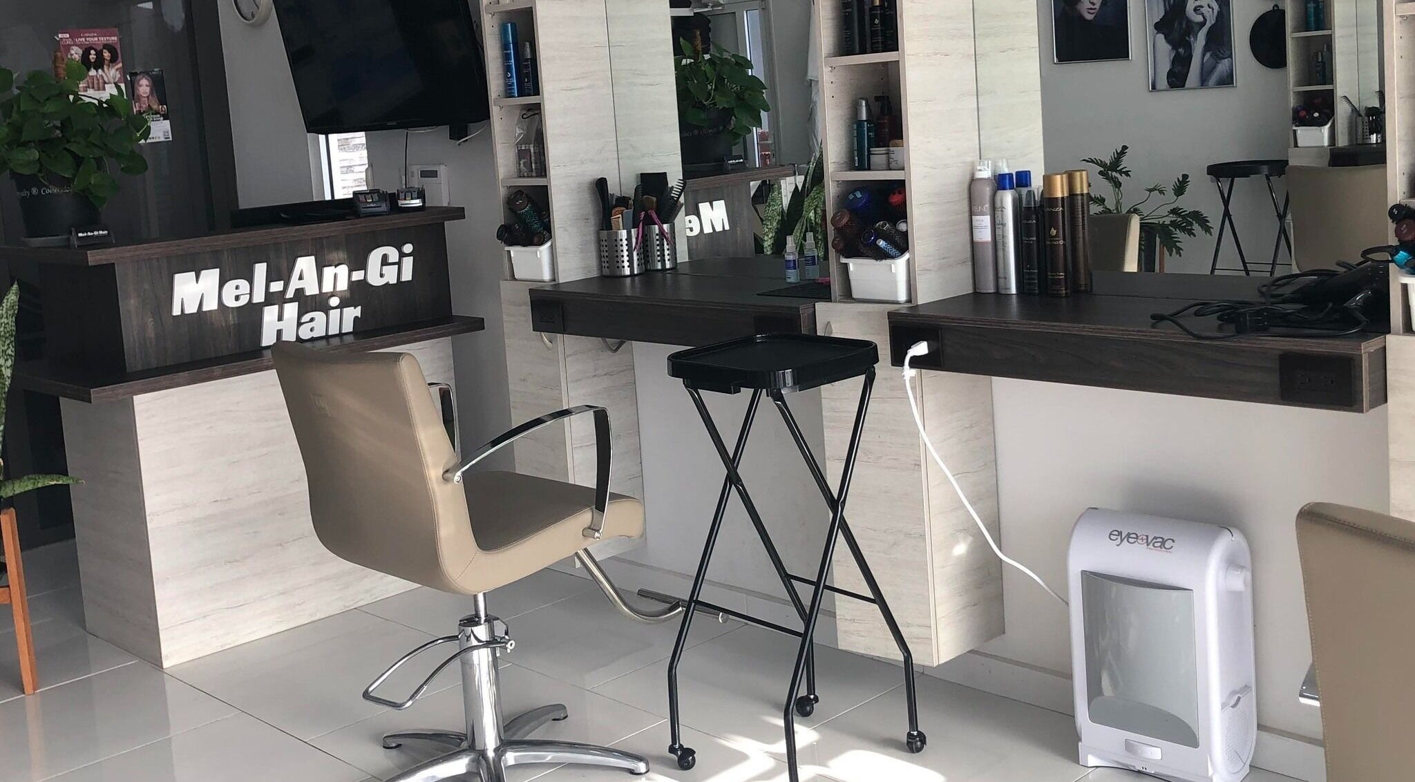 Chic salon workstation at Mel An Gi Hair NV in Paramaribo, Paramaribo, SR, featuring modern decor and beauty products.