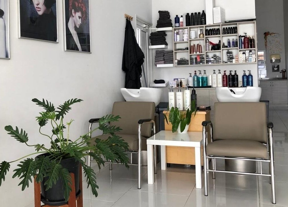 Modern interior of Mel An Gi Hair NV with chairs and products in Paramaribo, Paramaribo, SR.