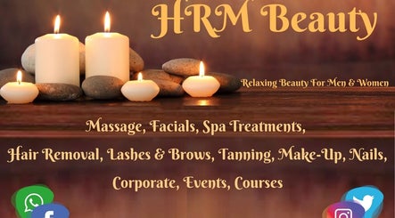 Candles and spa stones at HRM Beauty in Rayleigh, England offering massages, facials, and spa treatments.