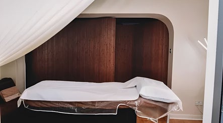 Massage room at HRM Beauty, Rayleigh, England, GB featuring a comfortable treatment bed and calming ambiance.