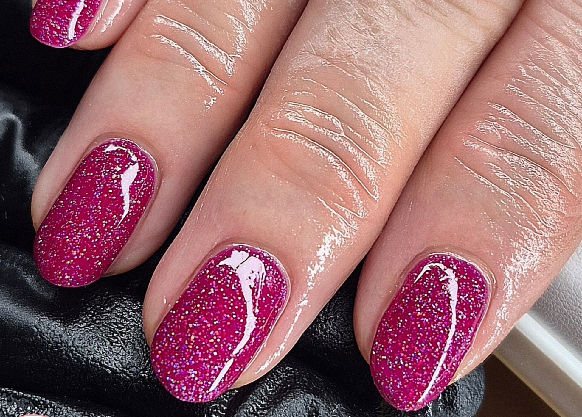 Sparkling pink glitter nails at Fi Fi's Beauty in Fareham, England, GB, showcasing expert nail artistry.