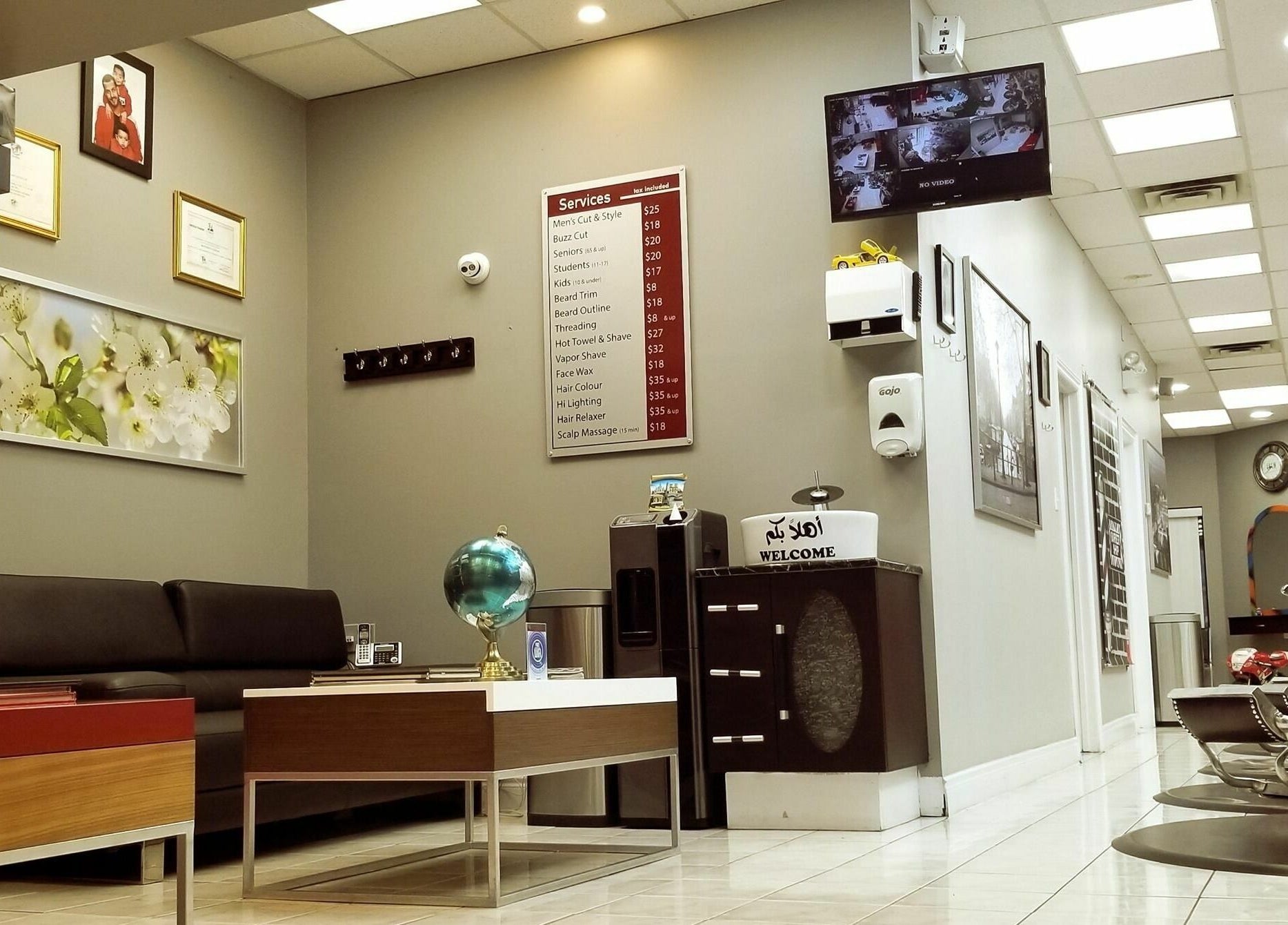 Modern interior of Adam's Barber Chair in Mississauga, Ontario, CA with chairs and service menu.
