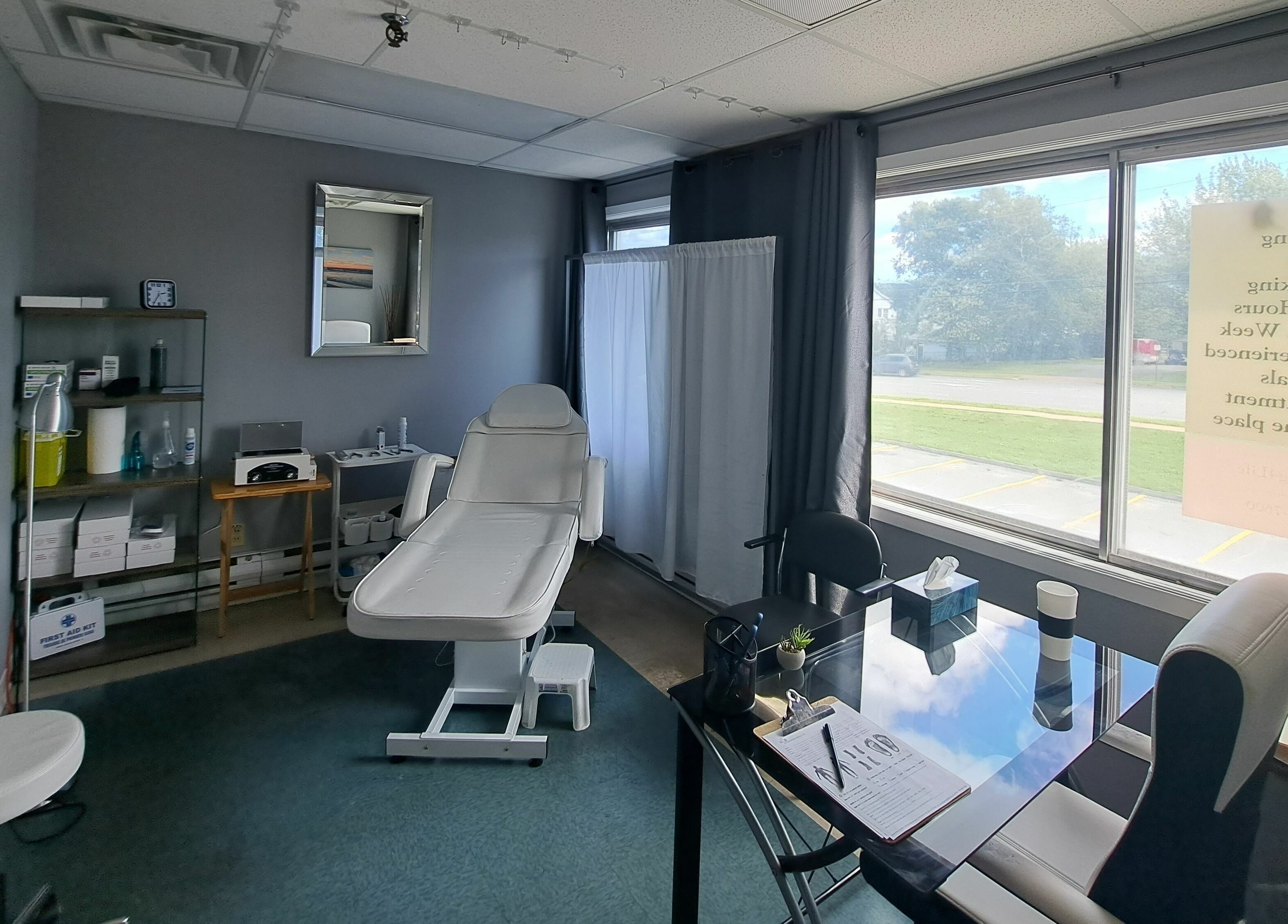Treatment room at Holistic Healing 4 Life in Dartmouth, Nova Scotia, CA with a white therapy chair and large windows.