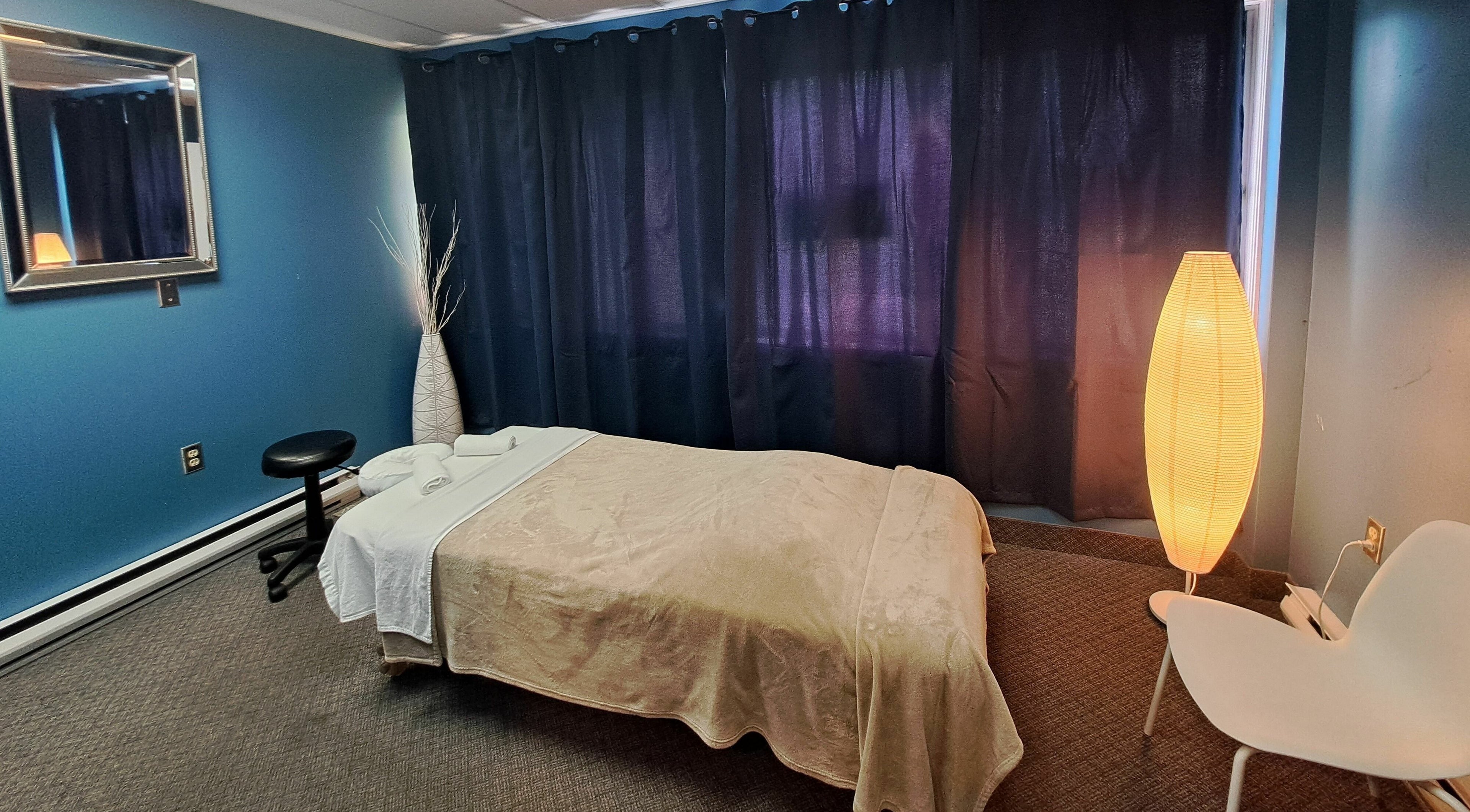Tranquil massage room at Holistic Healing 4 Life, Dartmouth, Nova Scotia, CA with soft lighting and cozy decor.