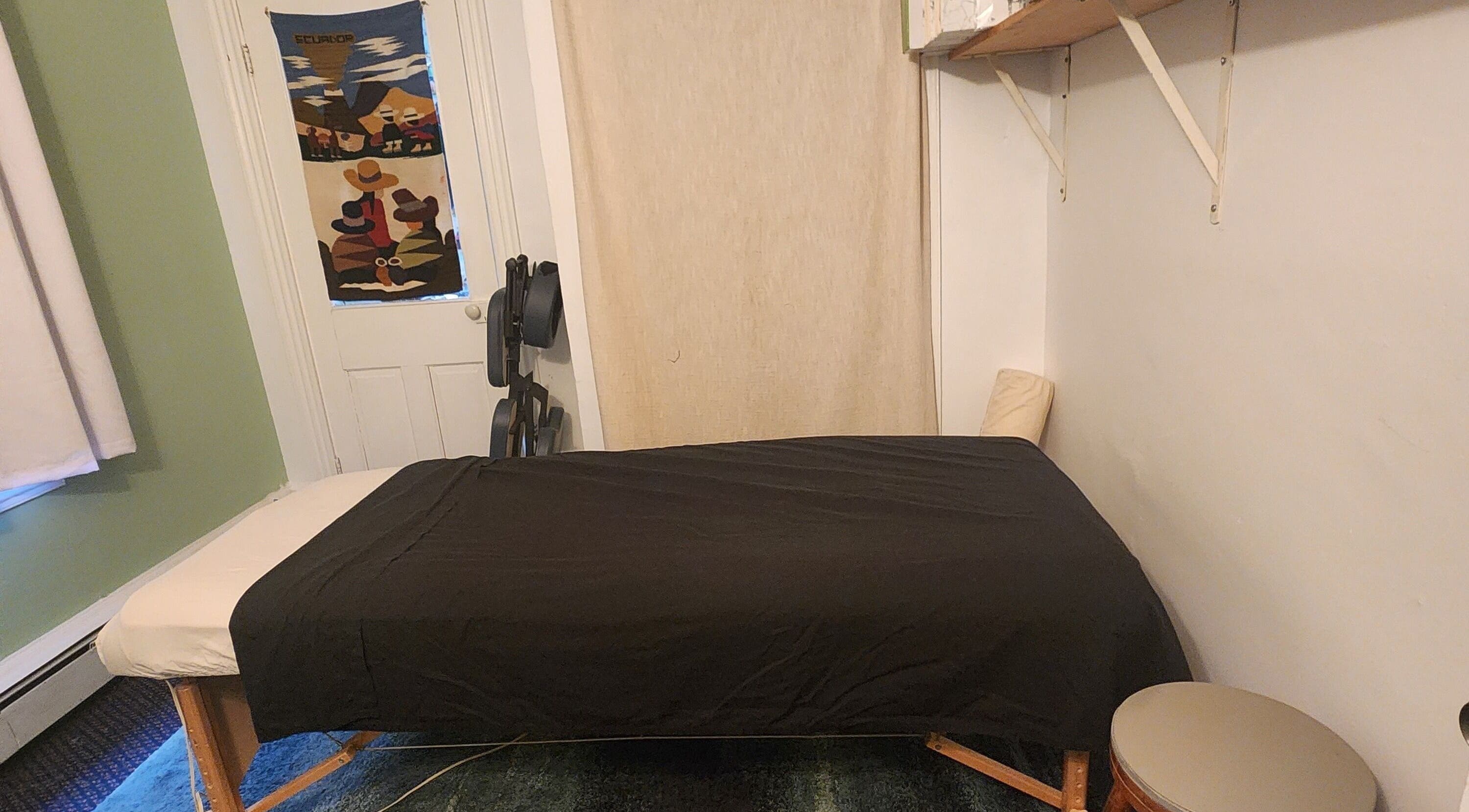 Massage room at Sana-Sana in Lancaster, Pennsylvania, US featuring a cozy black draped table.