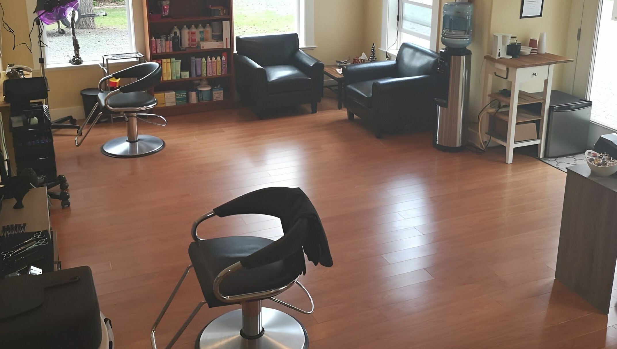 Cozy and modern interior of Kat's Hair Studio in Sooke, British Columbia, CA with stylish chairs and hair products.