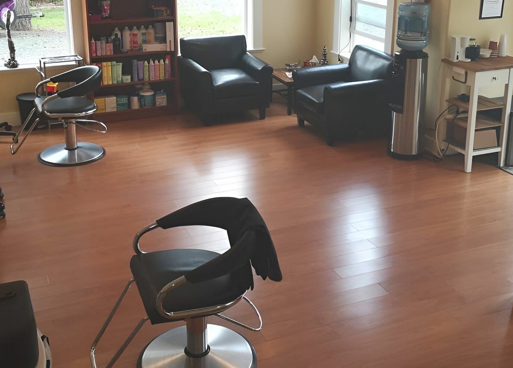 Cozy and modern interior of Kat's Hair Studio in Sooke, British Columbia, CA with stylish chairs and hair products.