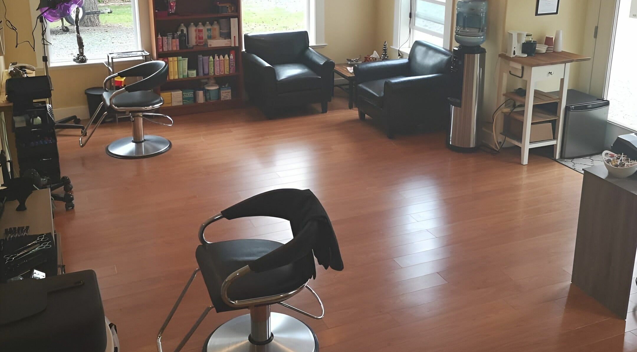 Cozy and modern interior of Kat's Hair Studio in Sooke, British Columbia, CA with stylish chairs and hair products.