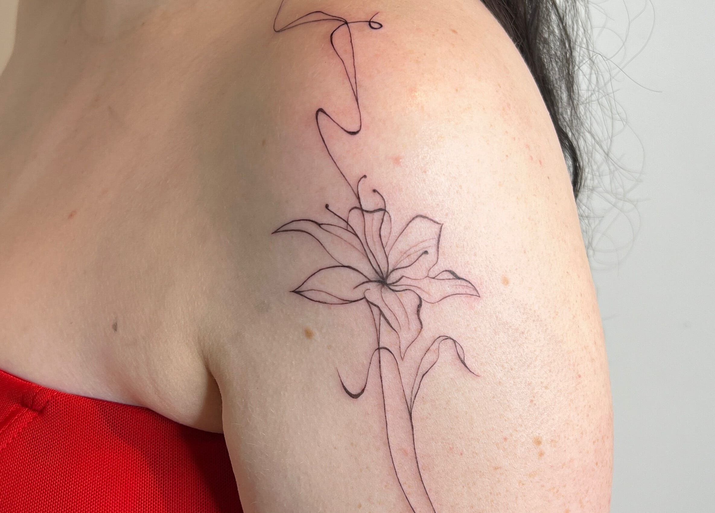 Delicate floral tattoo on shoulder at Inkd Aesthetics, Surfers Paradise, Queensland, AU.