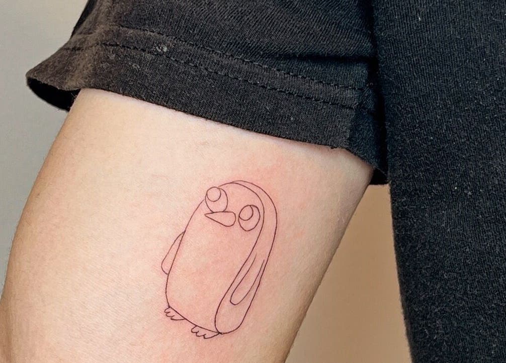 Minimalist penguin tattoo on arm at Inkd Aesthetics, Surfers Paradise, Queensland, AU.