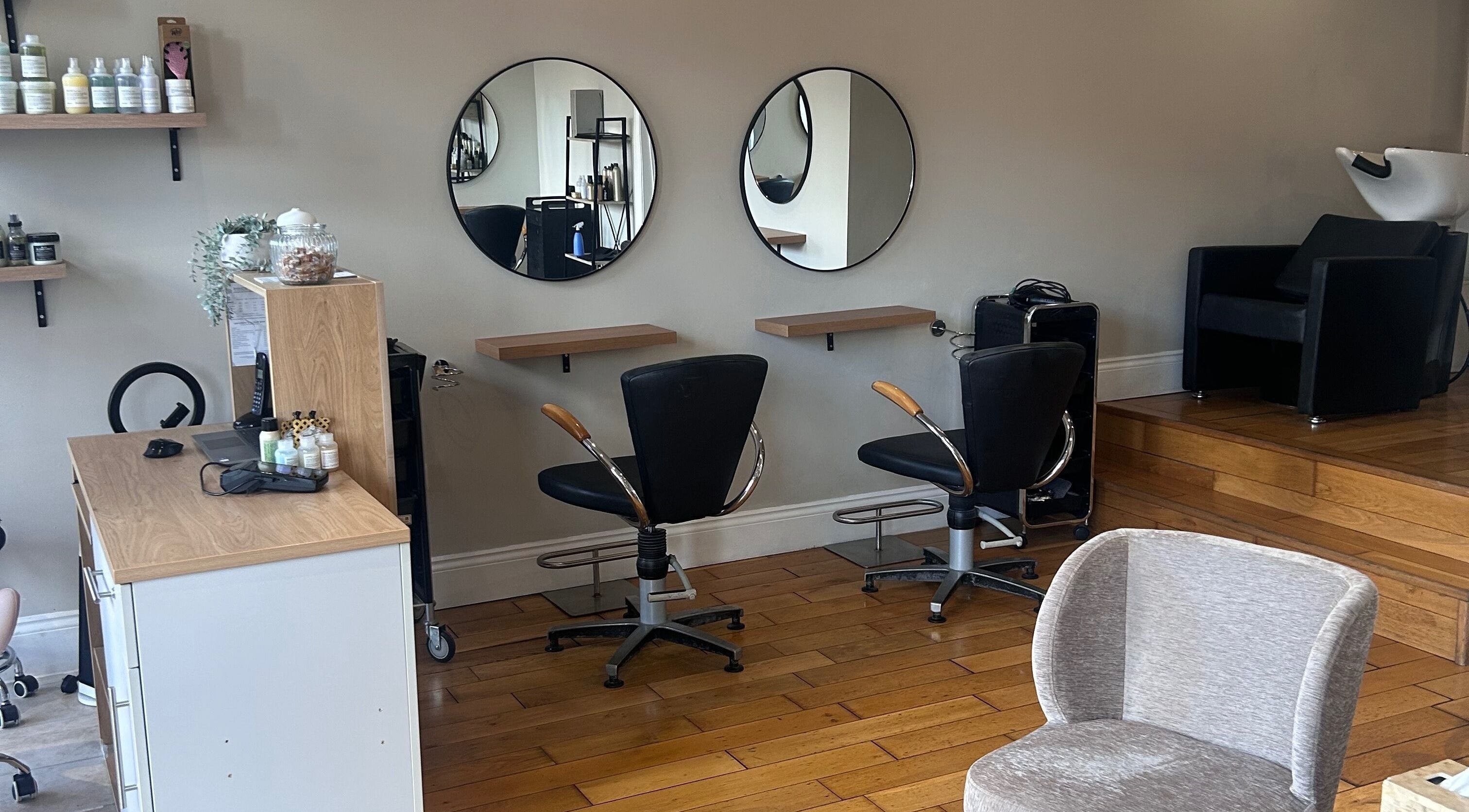 Modern styling area at Cosy Hair Lounge, Market Harborough, England, GB. Elegant and inviting interior.