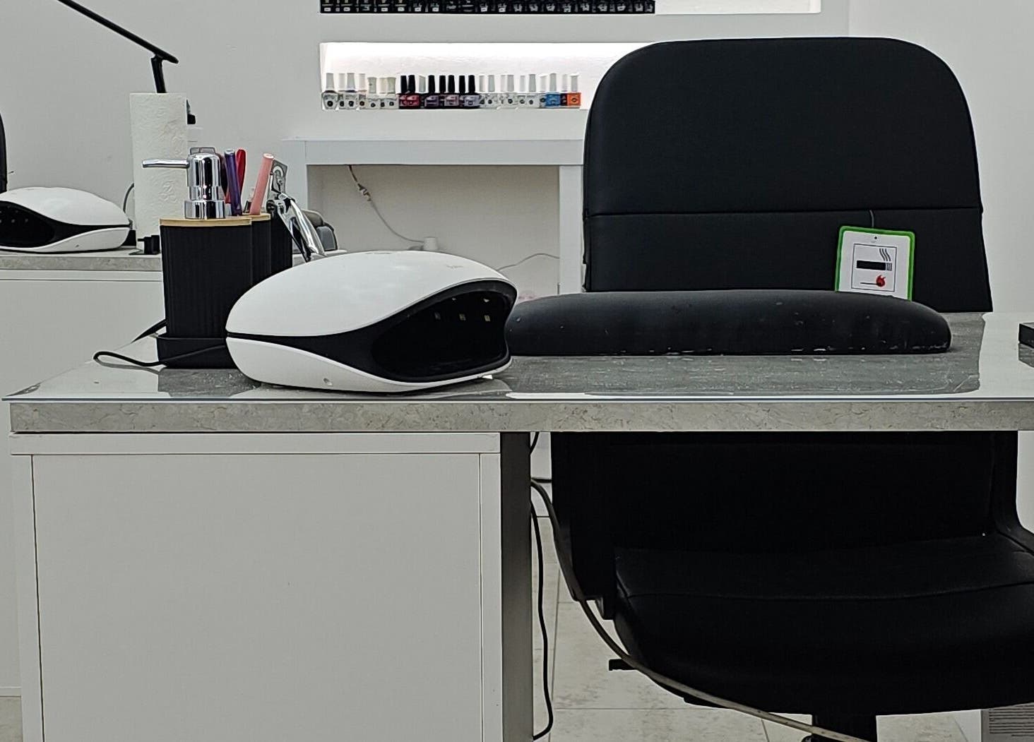 Modern nail station at Nude Skin Clinic (Naomi), Manchester, England, GB, showcasing professional manicure setup.