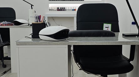 Modern nail station at Nude Skin Clinic (Naomi), Manchester, England, GB, showcasing professional manicure setup.