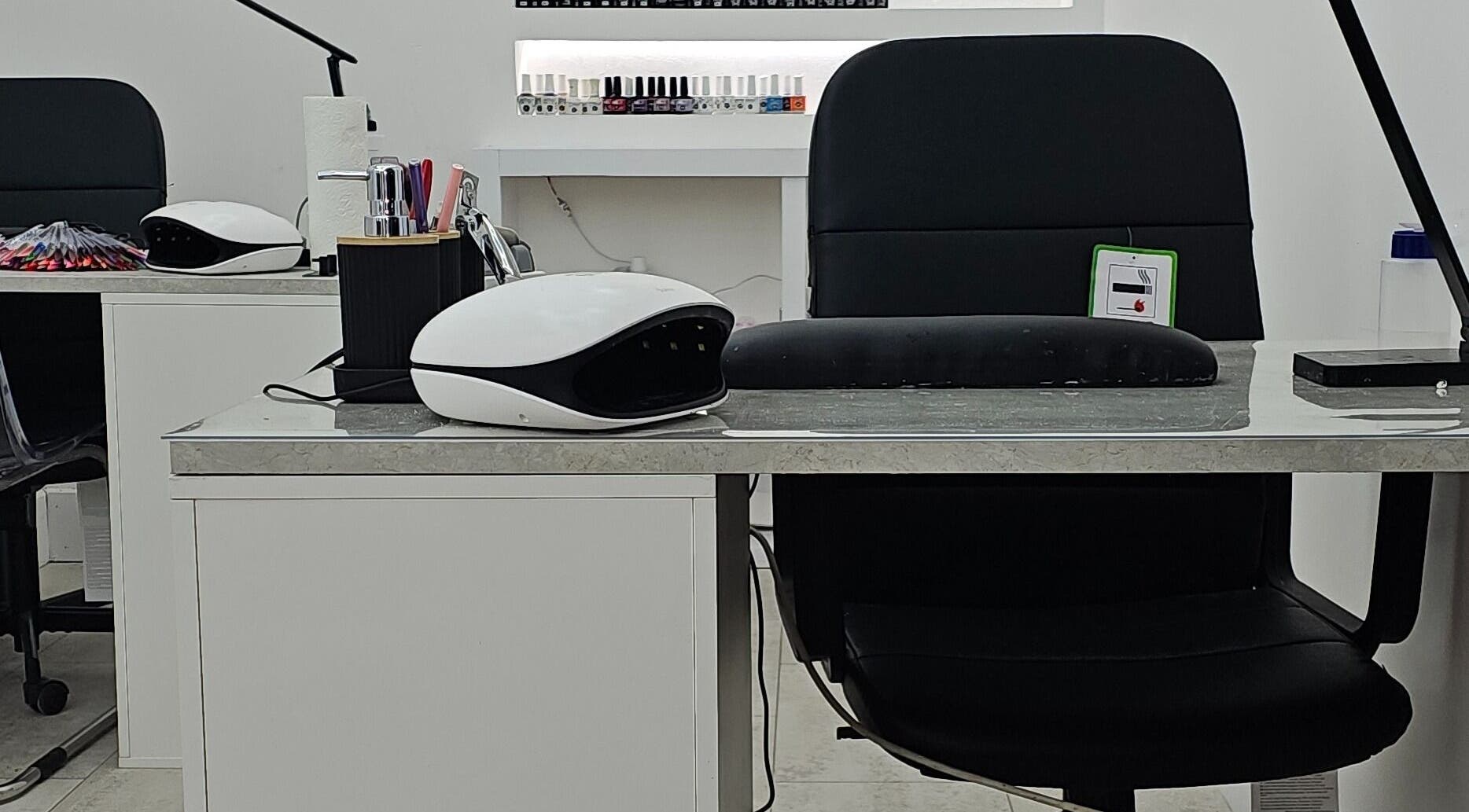 Modern nail station at Nude Skin Clinic (Naomi), Manchester, England, GB, showcasing professional manicure setup.