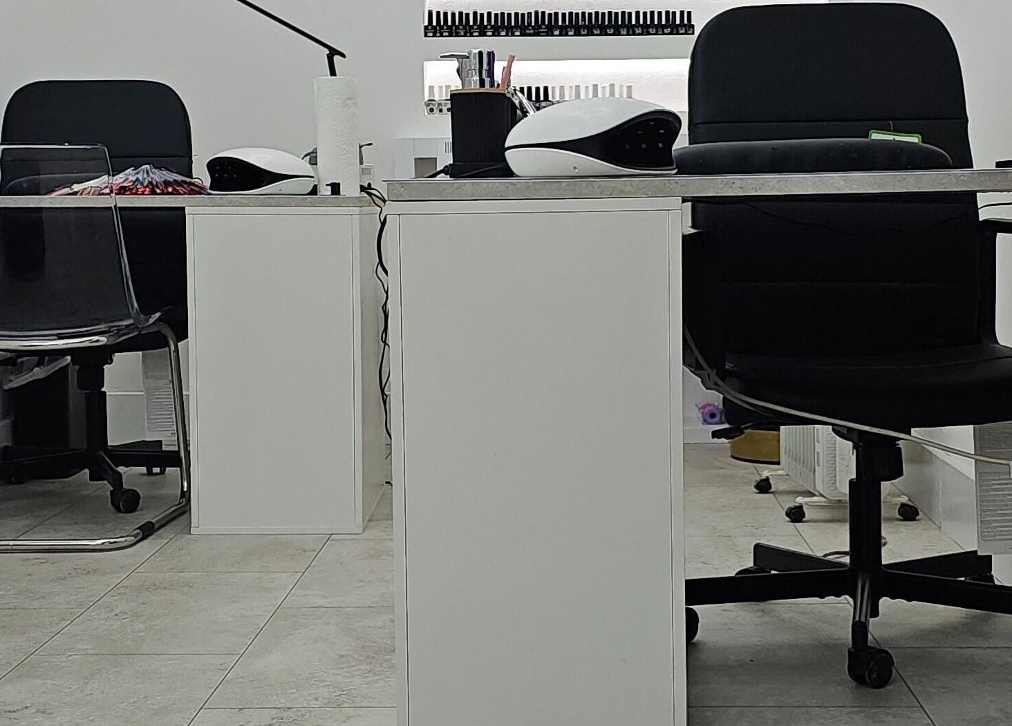 Modern nail station at Nude Skin Clinic (Naomi) in Manchester, England, GB, showcasing sleek chairs and tidy surfaces.