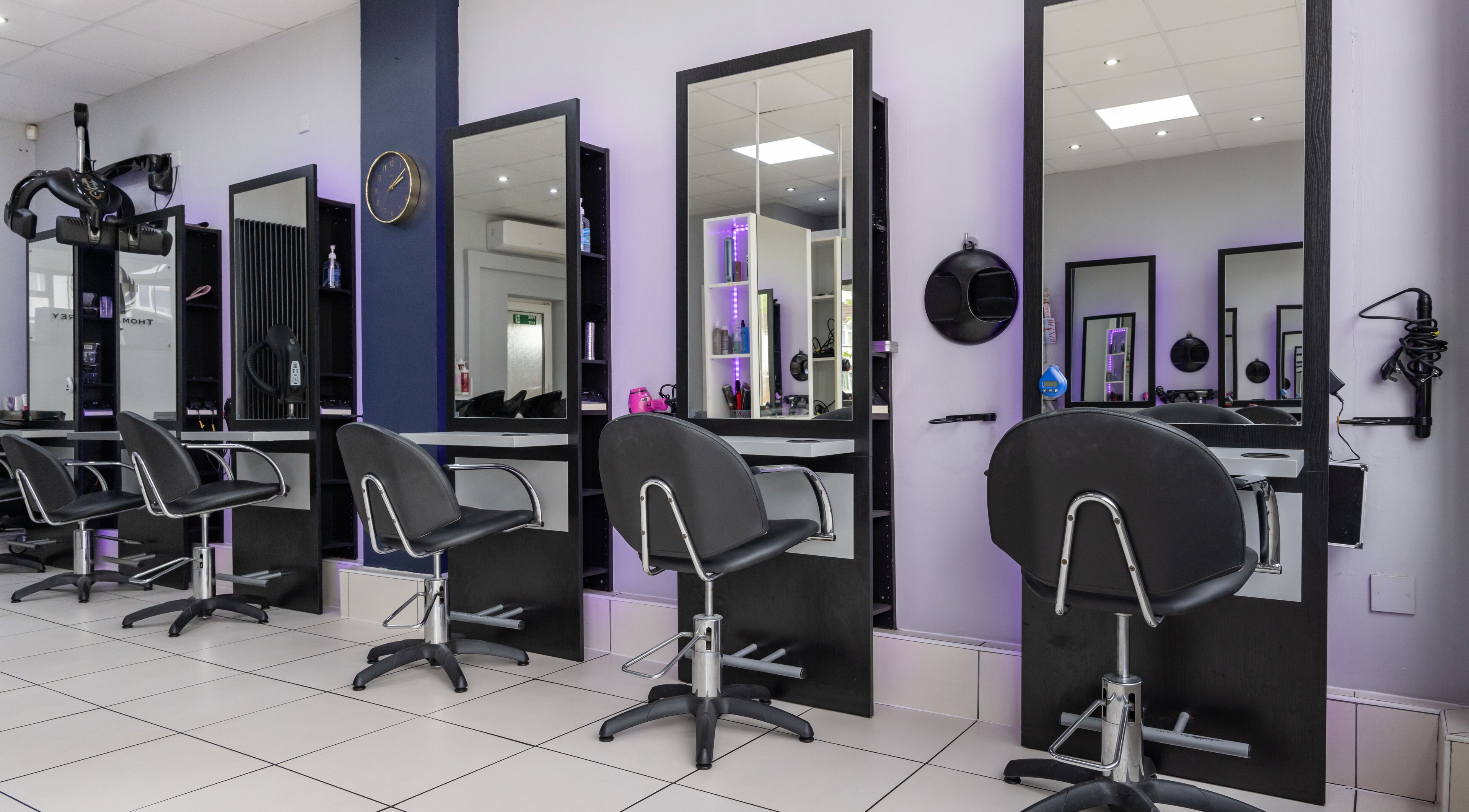 Modern hair stations at Thomas Jeffrey Hair, Coventry, England, GB. Sleek design with mirrors and salon chairs.