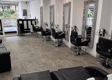 Sleek styling chairs at Gemma Louise Hair and Beauty, Rawtenstall, England, GB with ornate mirrors in view.