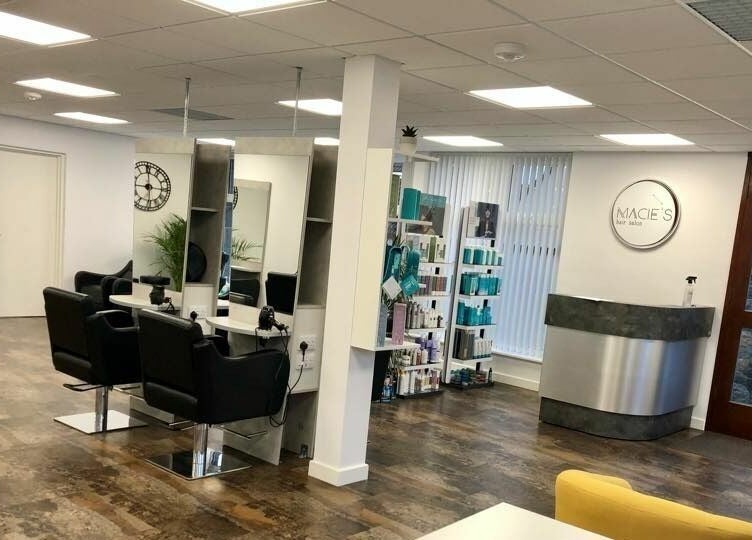 Modern salon interior at Macie's in Guernsey, Castel, GG with stylish chairs and product display.