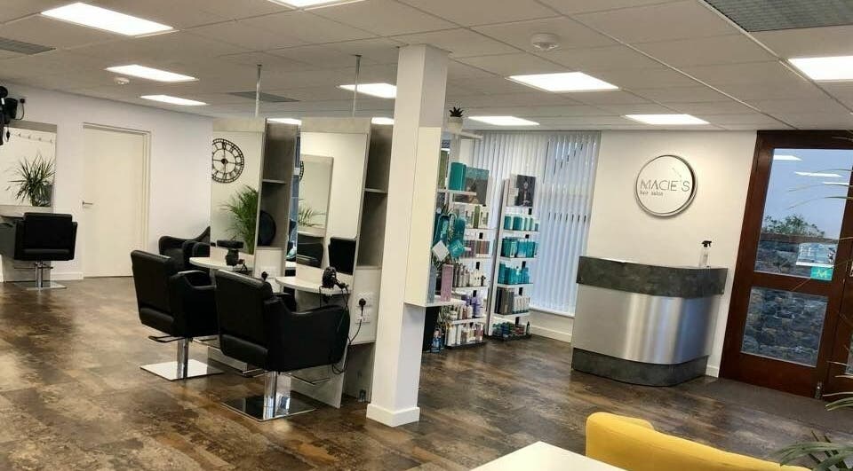 Modern salon interior at Macie's in Guernsey, Castel, GG with stylish chairs and product display.