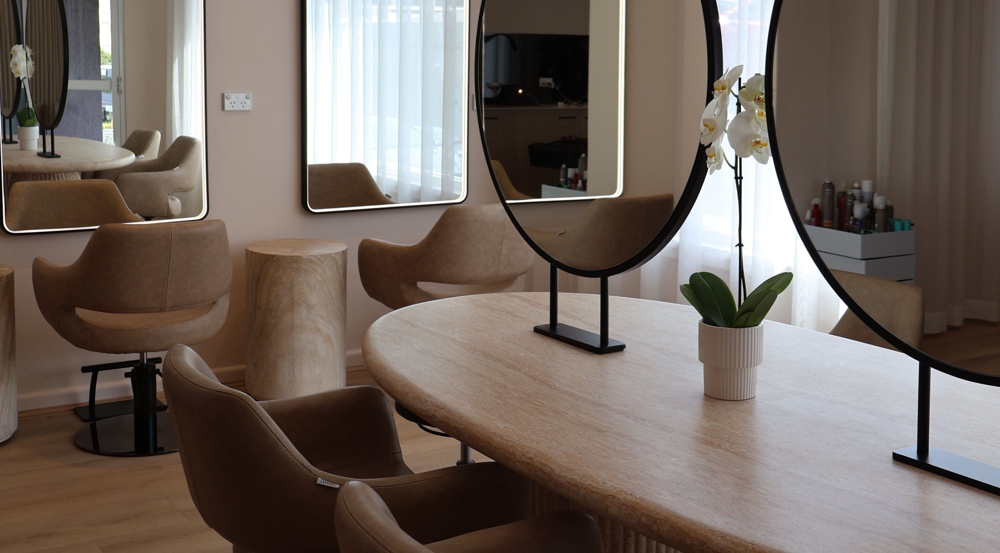 Sleek salon interior with stylish chairs and mirrors at Lushed Beauty, Wollongong, New South Wales, AU.
