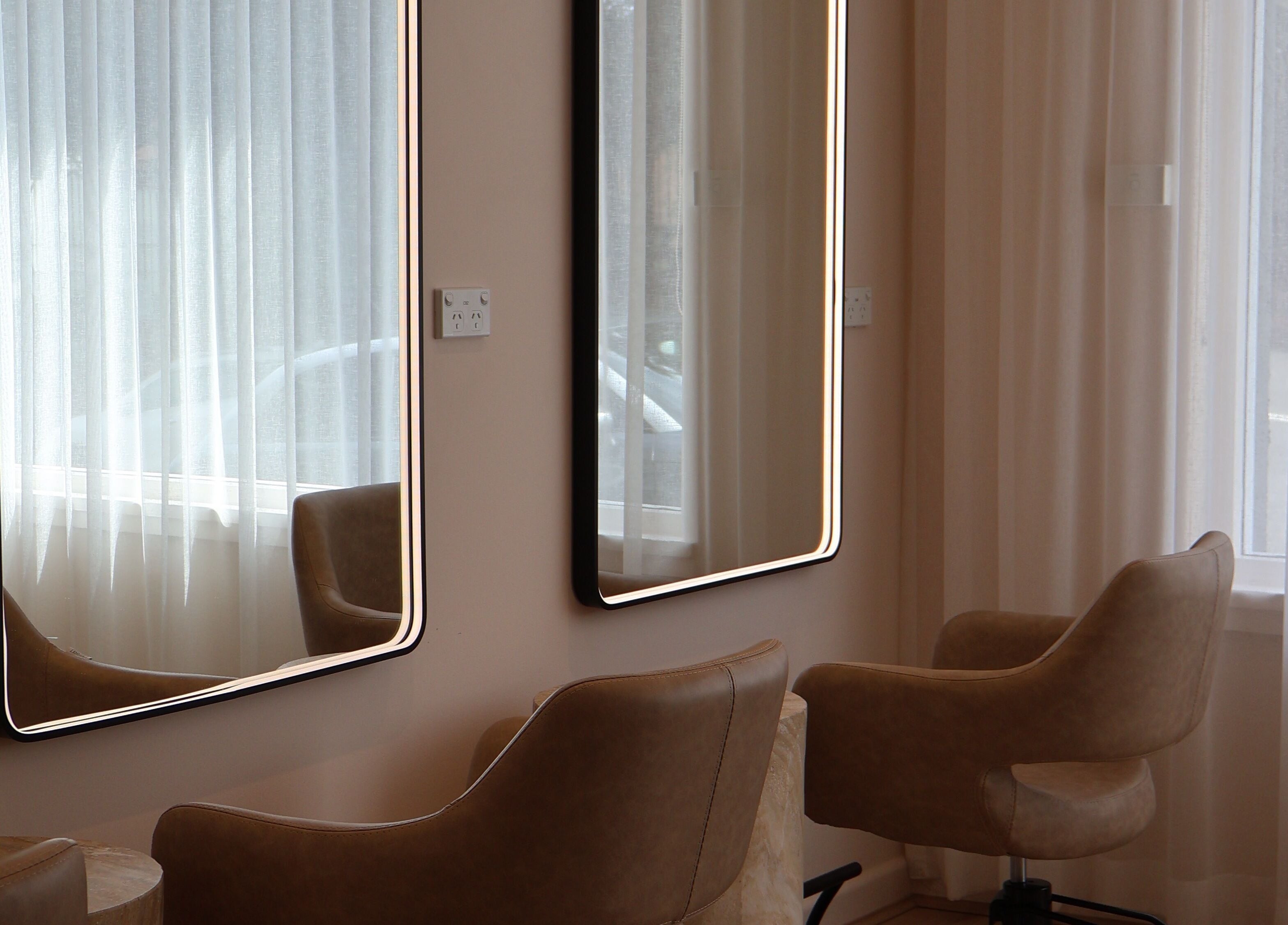 Chic salon seating at Lushed Beauty, Wollongong, New South Wales, AU with modern illuminated mirrors.