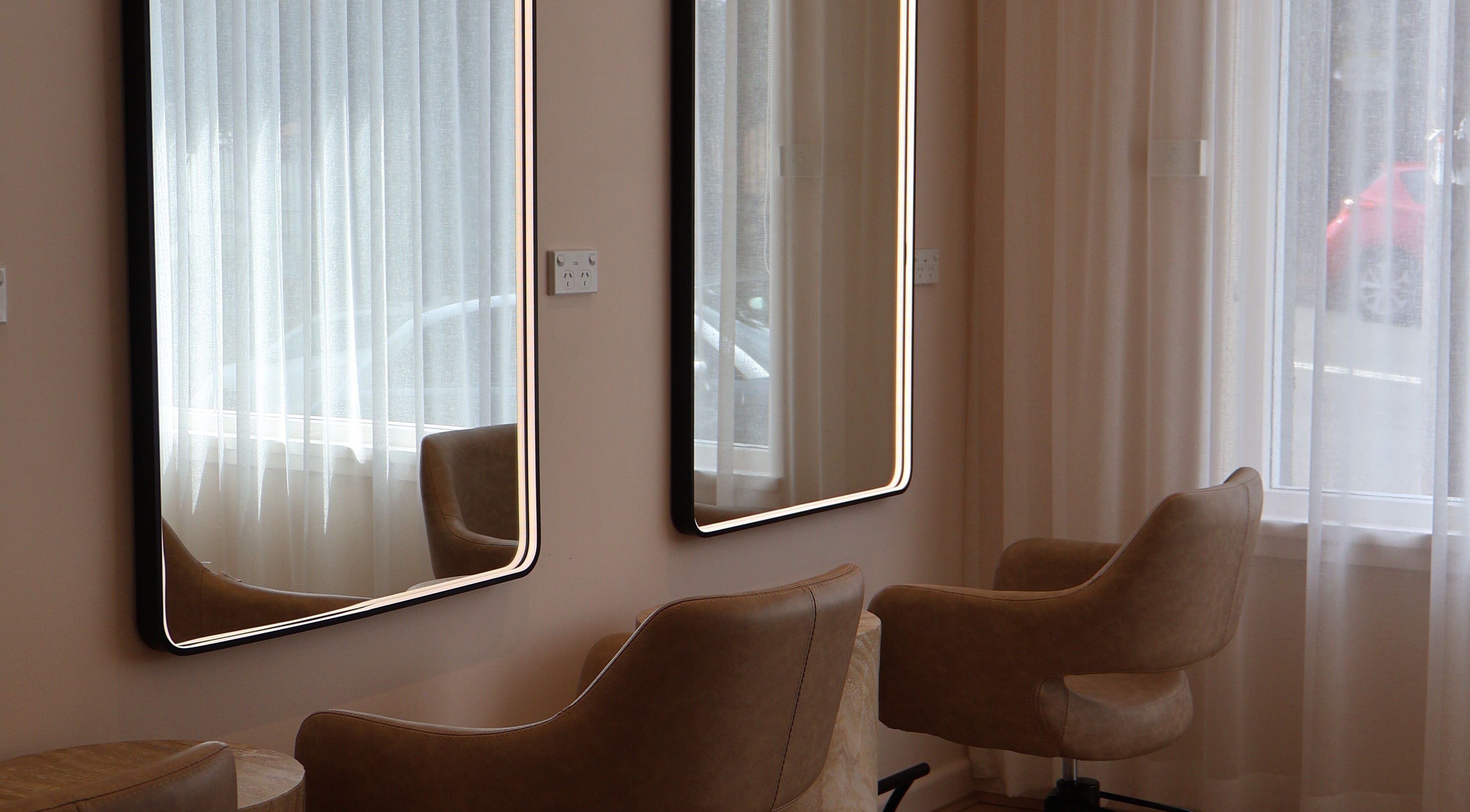 Chic salon seating at Lushed Beauty, Wollongong, New South Wales, AU with modern illuminated mirrors.