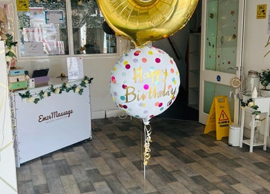 Emz4massage Ilkeston reception with birthday balloons and spa decor, creating a welcoming atmosphere.