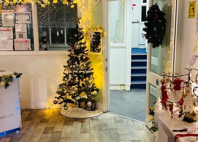 Emz4massage in Ilkeston, England, GB features a festive decor with a lit Christmas tree and holiday ornaments.