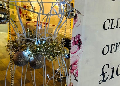 Decorated display at Emz4massage with festive ornaments in Ilkeston, England, GB highlighting a client offer.