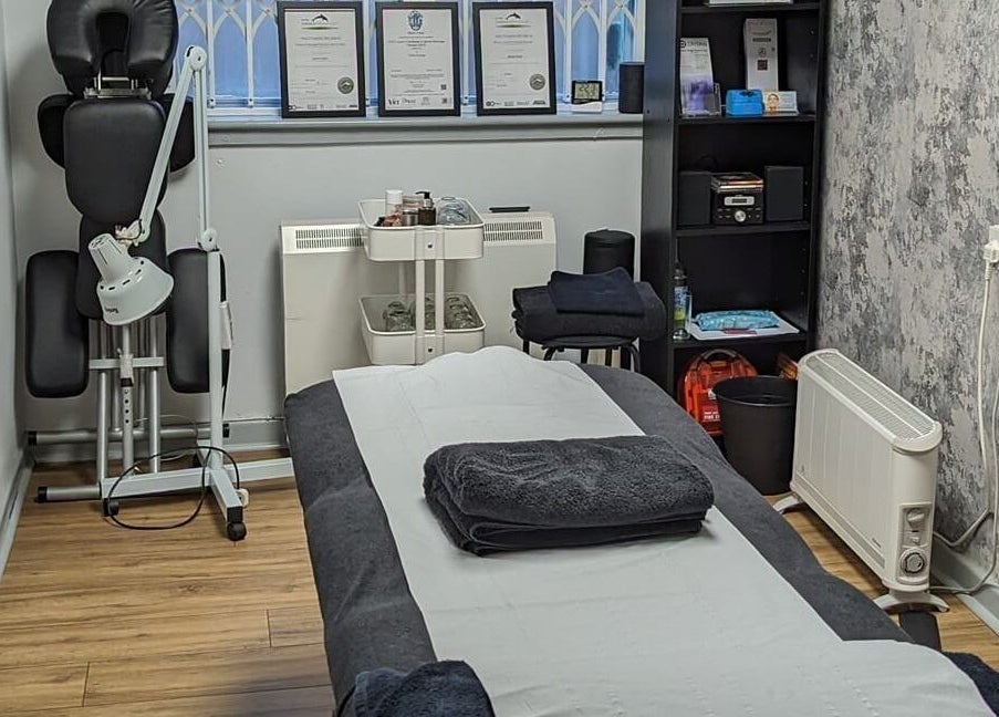 Therapy room at The Hub New Mills, New Mills, England, GB, featuring a massage table and certificates.