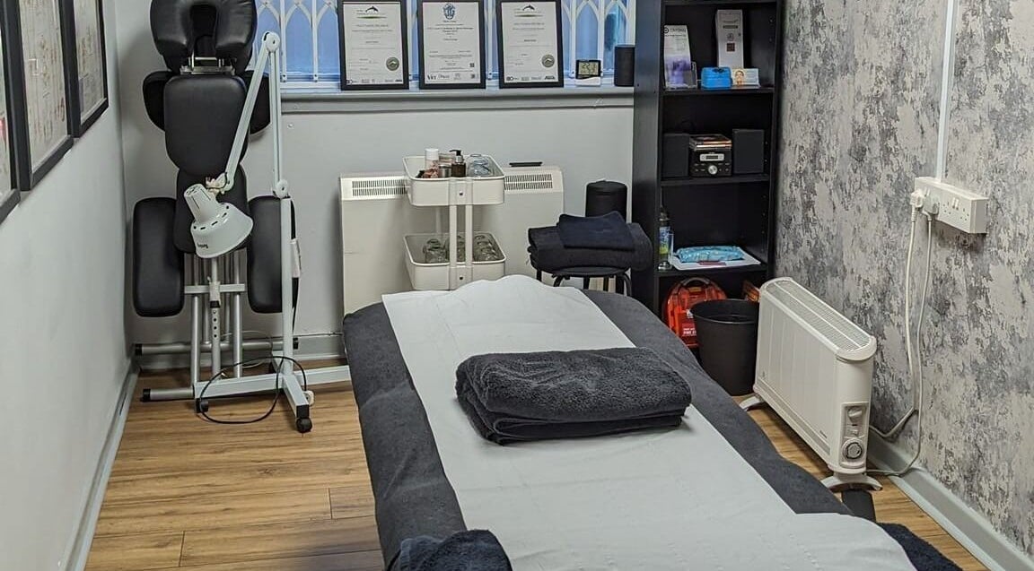 Therapy room at The Hub New Mills, New Mills, England, GB, featuring a massage table and certificates.