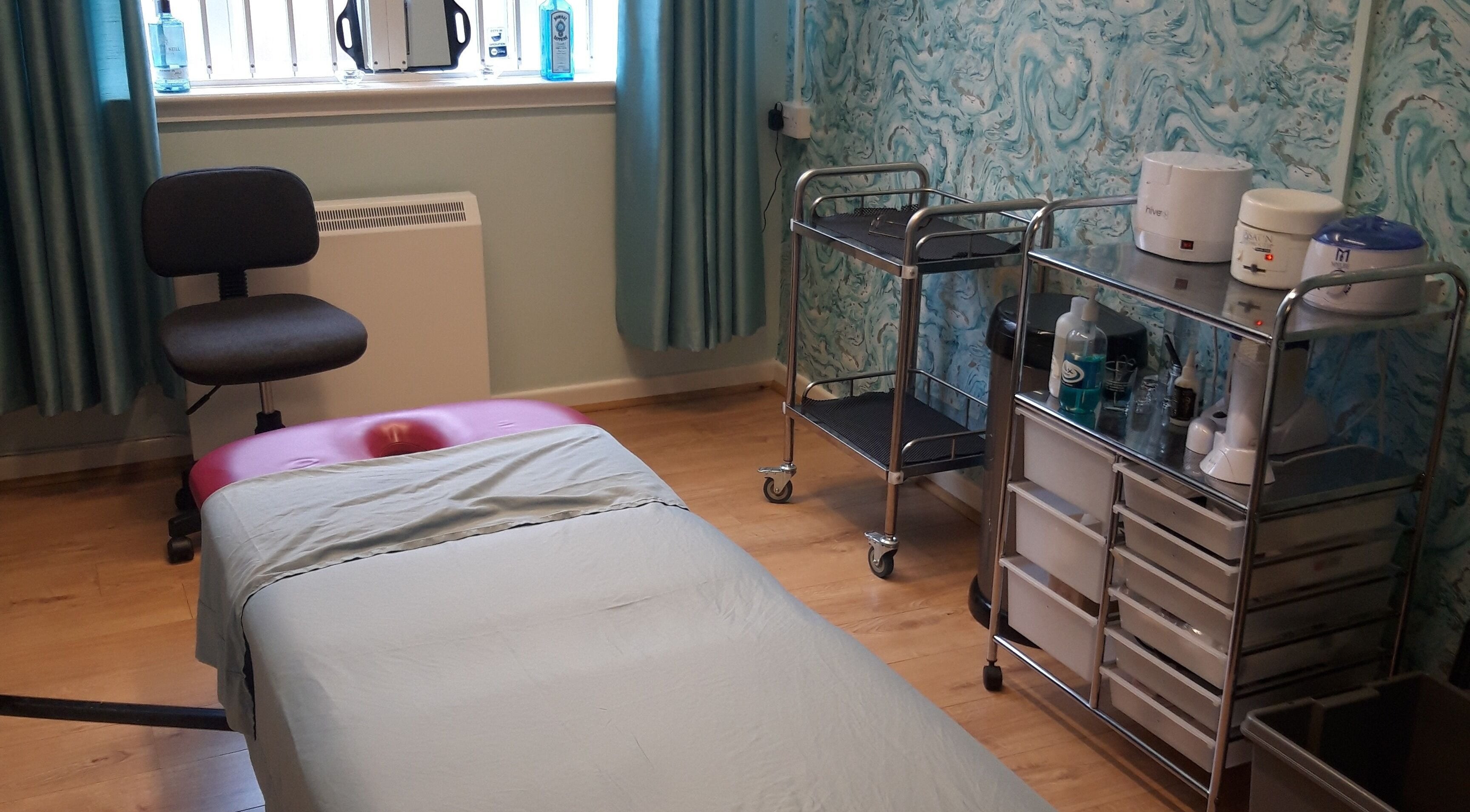 Therapy room at The Hub New Mills, New Mills, England. Features a treatment bed and wellness equipment.