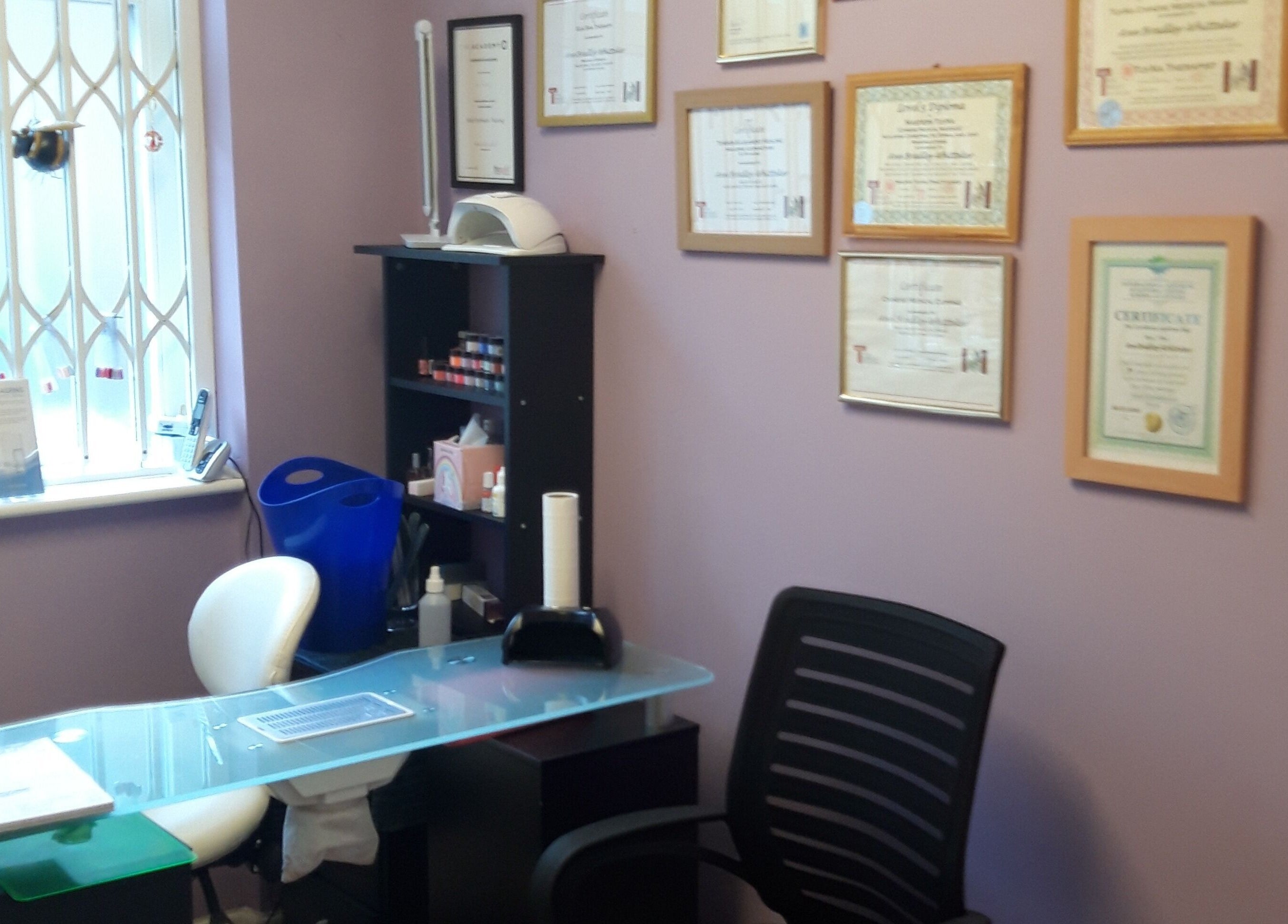 Inviting office space at The Hub New Mills, New Mills, England, GB. Displayed certifications and organized desk.