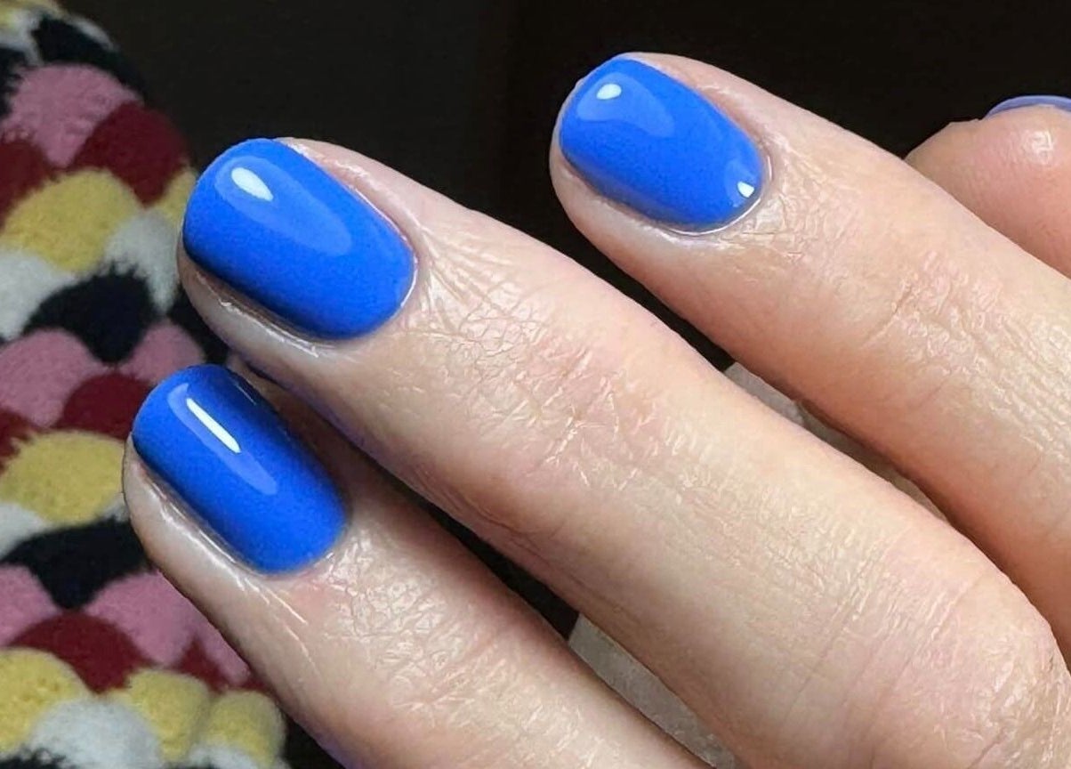 Close-up of vibrant blue polished nails at The Hub New Mills, New Mills, England, GB.