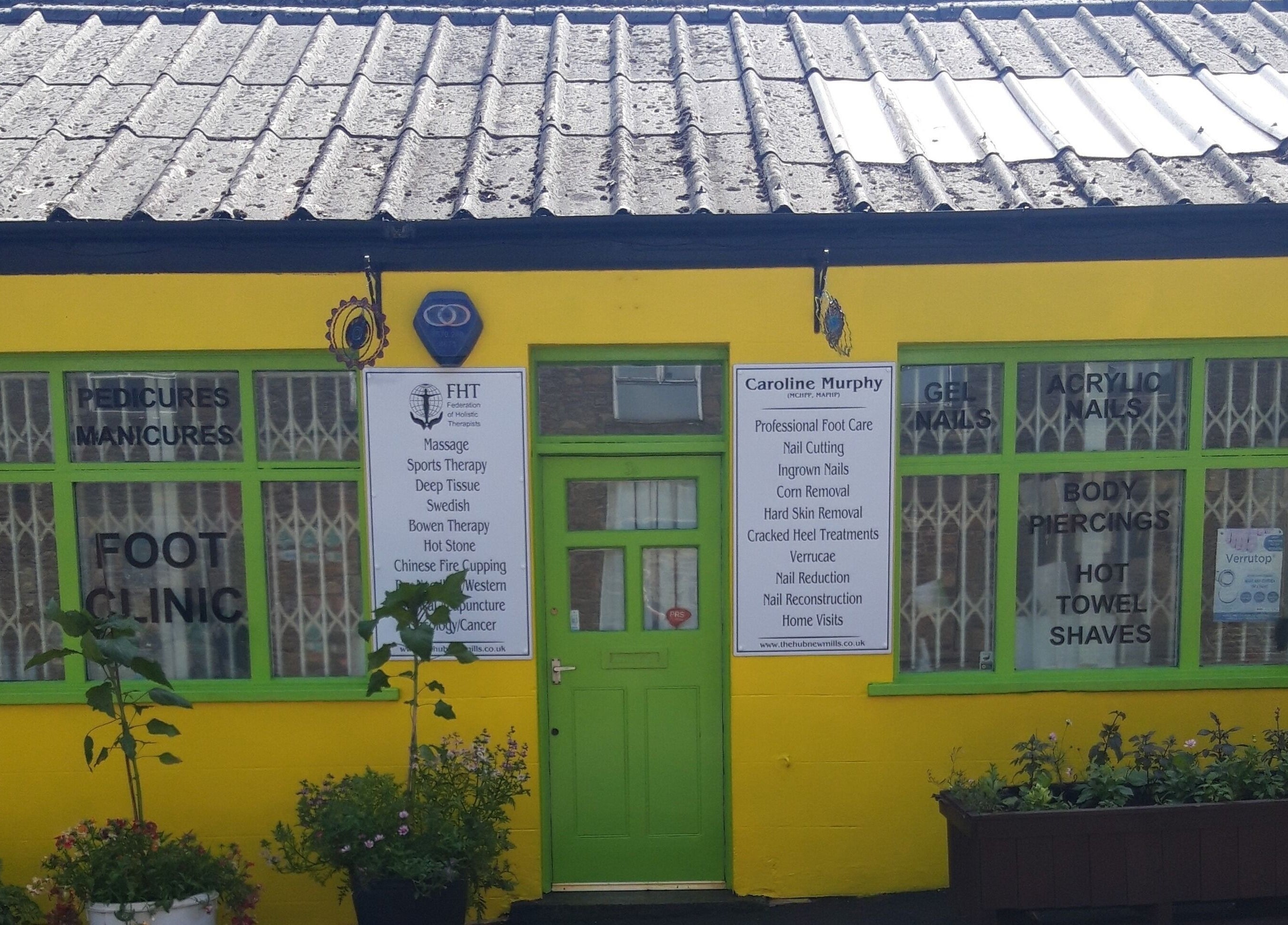 Bright yellow storefront of The Hub New Mills offering beauty and wellness services in New Mills, England, GB.