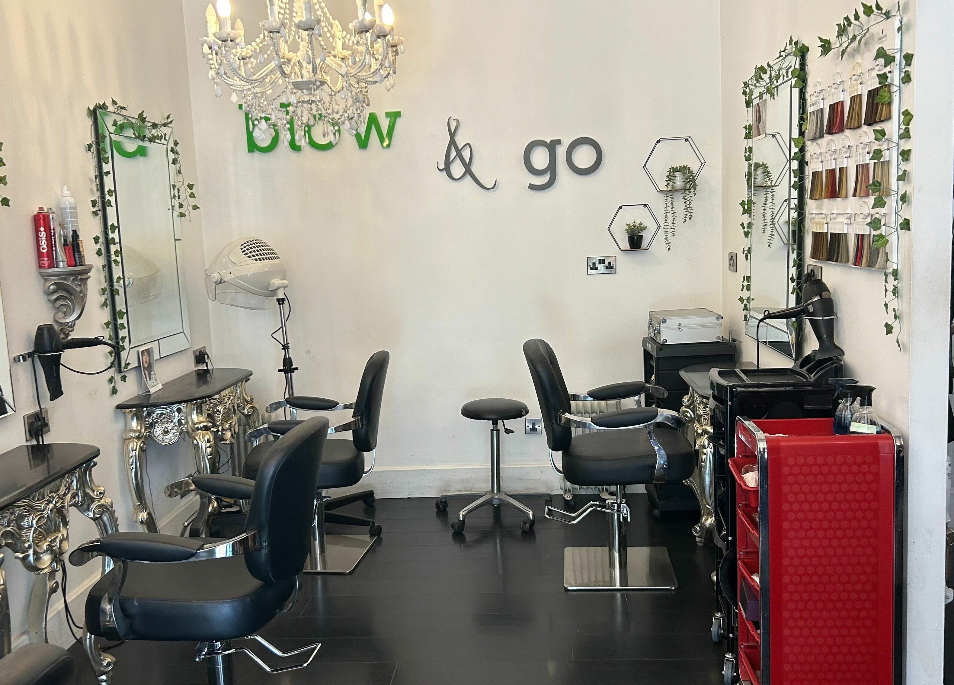 Elegant styling area at SY2 The Salon, Shrewsbury, England, GB with decorative mirrors and plush chairs.