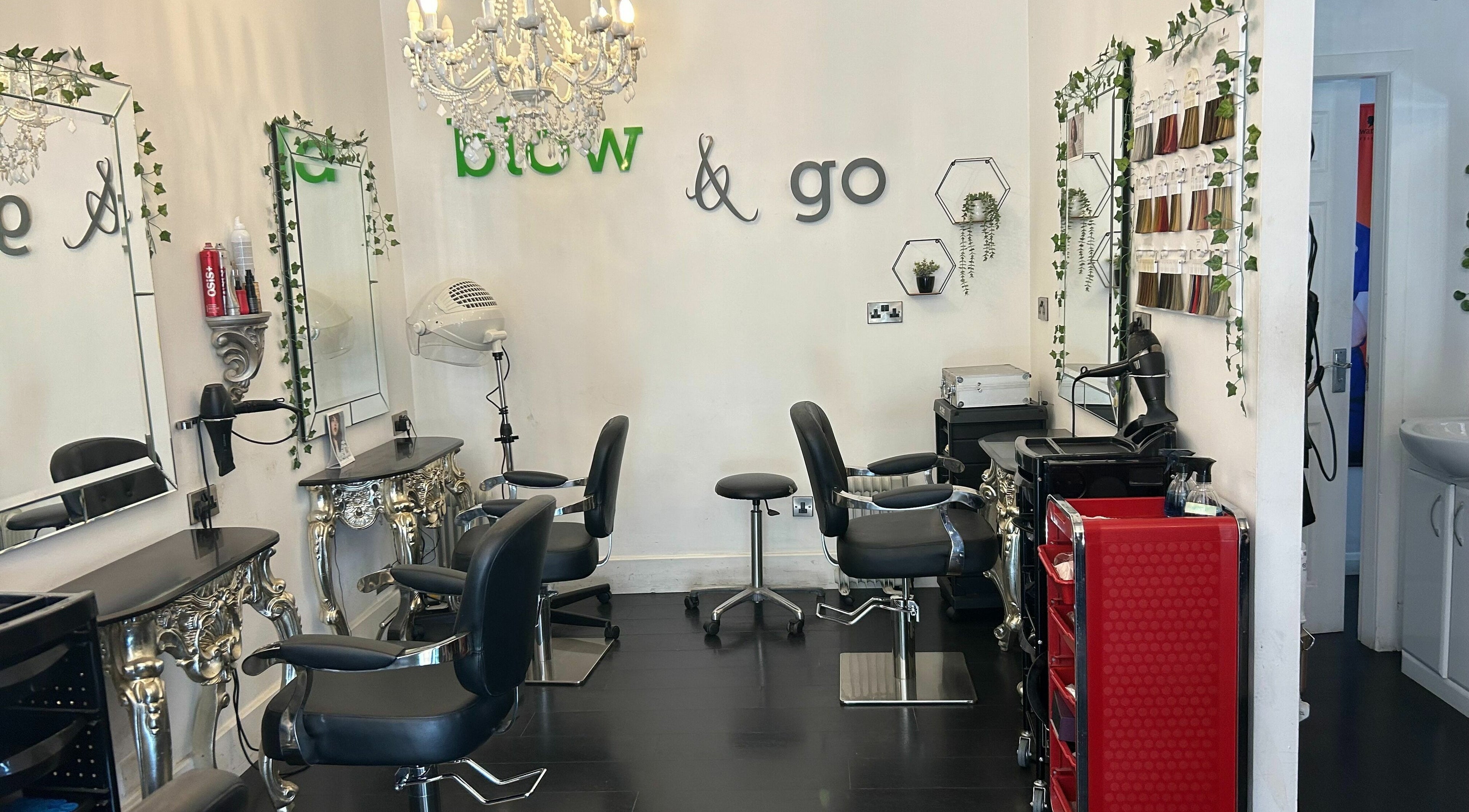 Elegant styling area at SY2 The Salon, Shrewsbury, England, GB with decorative mirrors and plush chairs.