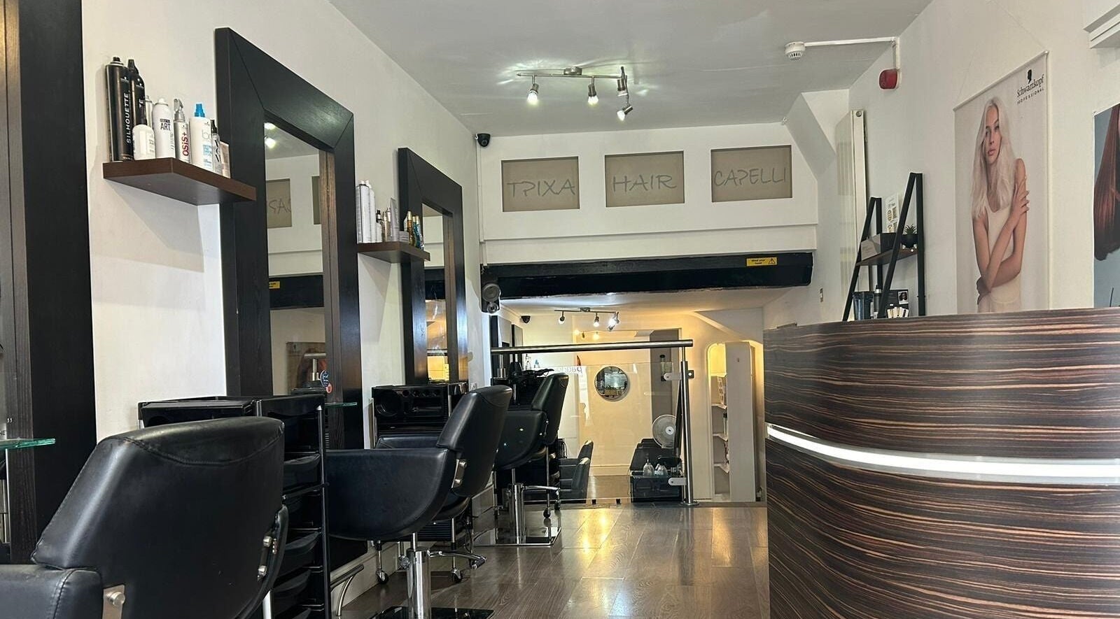 Interior of SY1 Hair in Shrewsbury, England, GB, featuring modern chairs and chic decor.