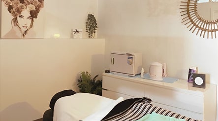 Calm treatment room at Personify Beauty, Speers Point, New South Wales, AU with massage table and decor.