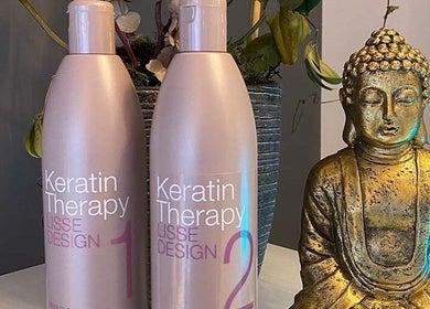 Keratin Therapy bottles beside a Buddha statue at Liz Cotter Styling, County Galway, County Galway, IE.