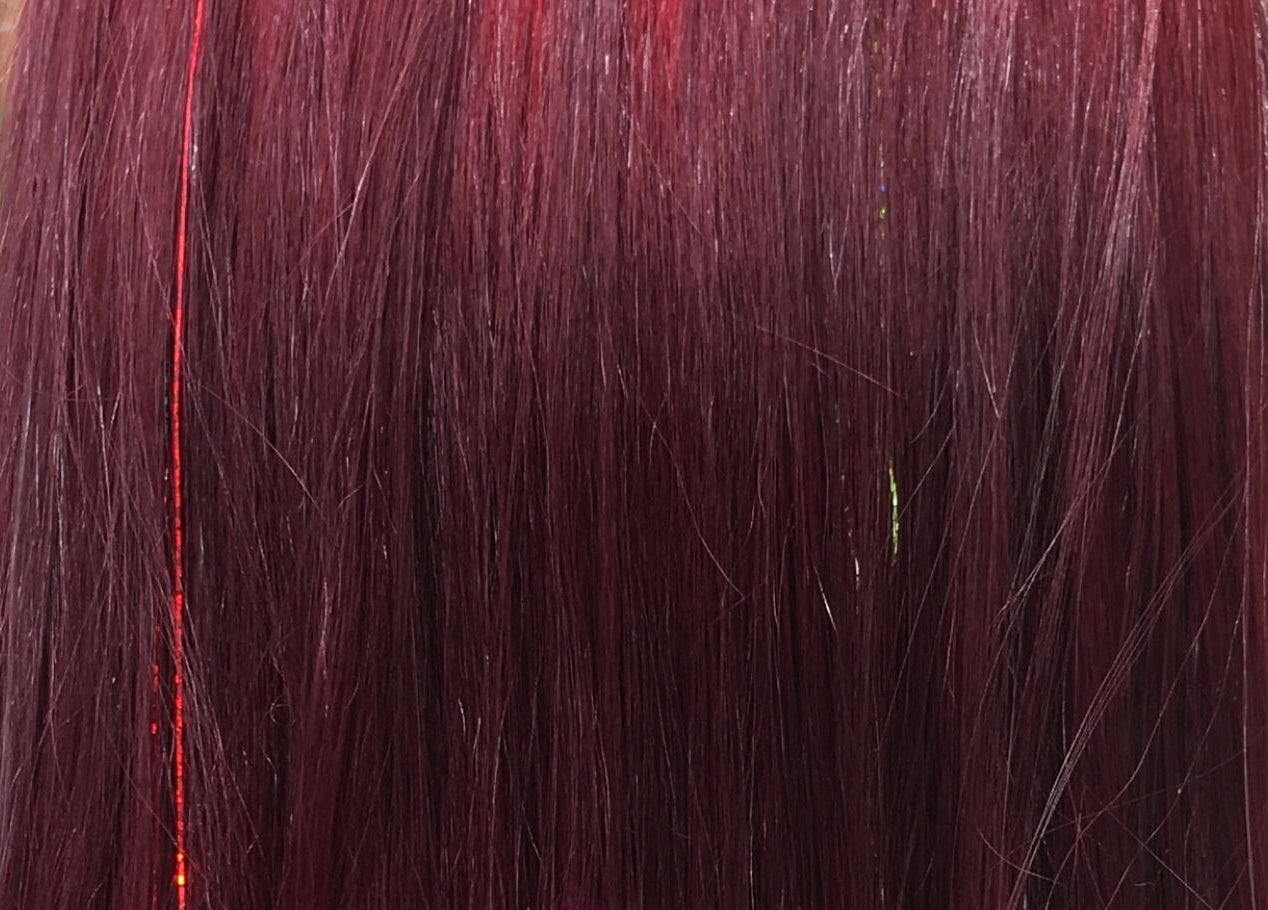 Vibrant crimson hair with a hint of shimmer at Gypsy Santa Fe, Santa Fe, New Mexico, US.