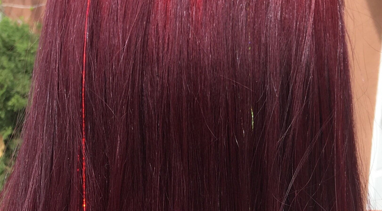 Vibrant crimson hair with a hint of shimmer at Gypsy Santa Fe, Santa Fe, New Mexico, US.