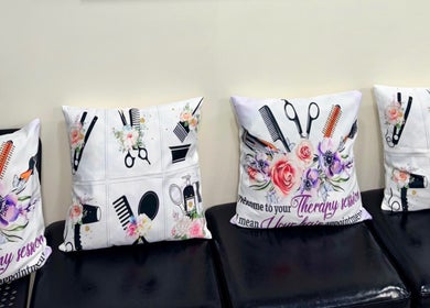 Decorative pillows with floral and salon tool designs at Haven Hair Salon, East Haven, Connecticut, US.