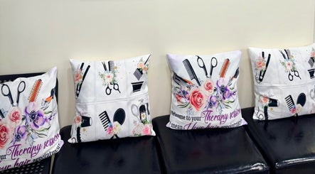 Decorative pillows with floral and salon tool designs at Haven Hair Salon, East Haven, Connecticut, US.