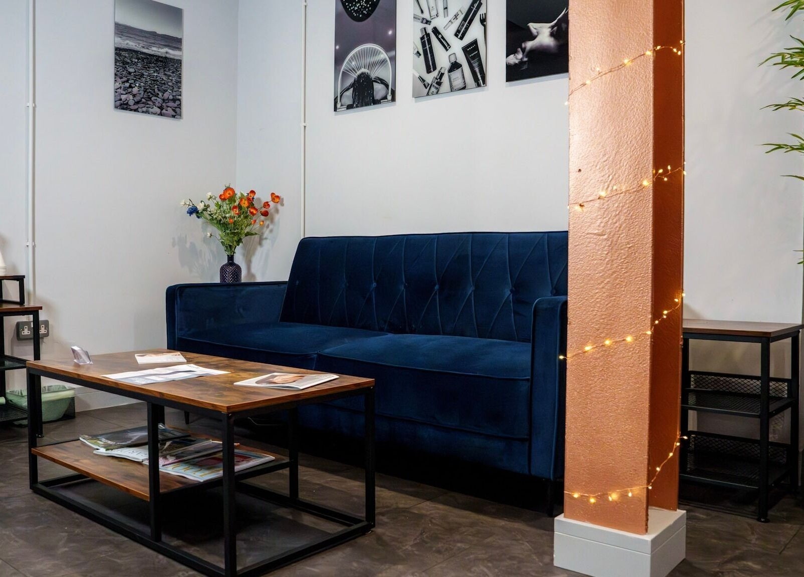 Elegant lounge at Socair Centre, Oban, Scotland, GB, featuring a blue sofa and decorative lights.