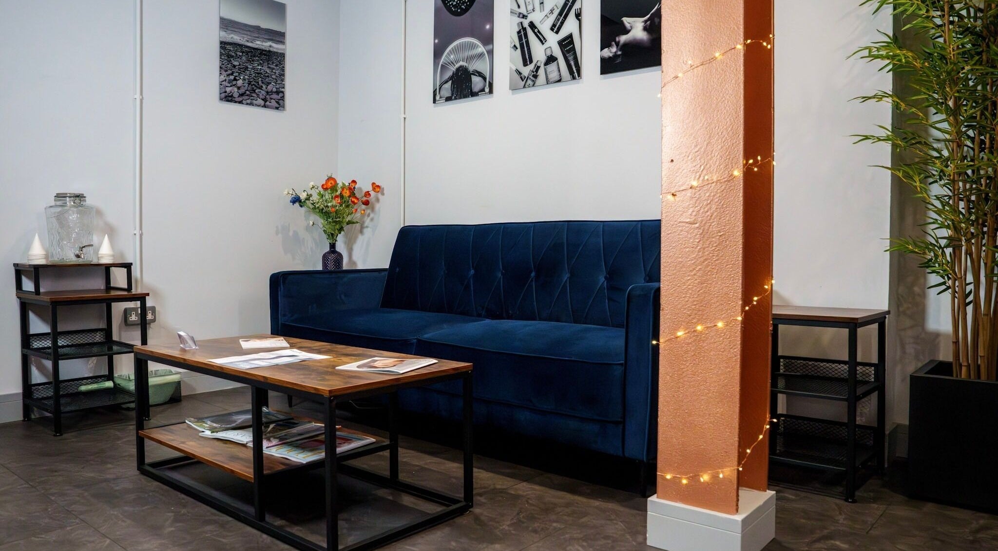 Elegant lounge at Socair Centre, Oban, Scotland, GB, featuring a blue sofa and decorative lights.