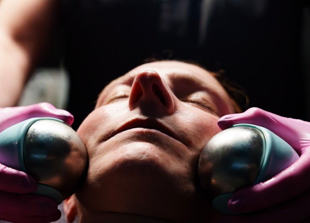 Relaxing facial at Socair Centre in Oban, Scotland, GB with cooling metal balls on cheeks for soothing experience.