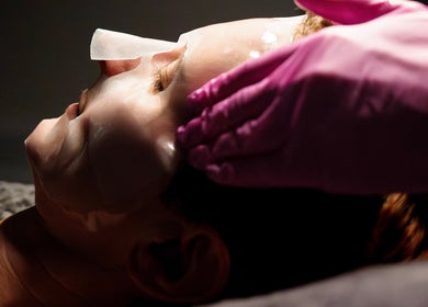 Facial treatment at Socair Centre, Oban, Scotland, GB. Gentle hands applying mask for rejuvenation.